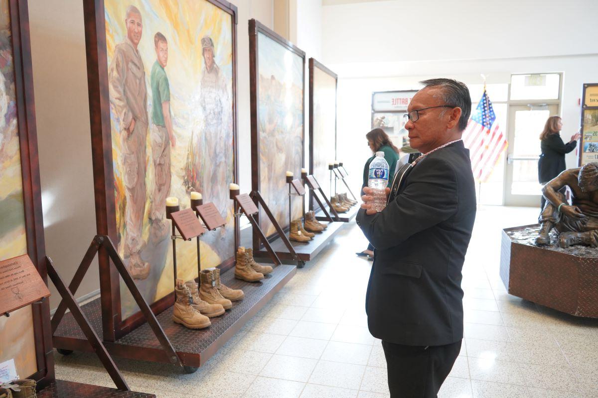 Dr. Nguyen in front of Eyes of Freedom display. 